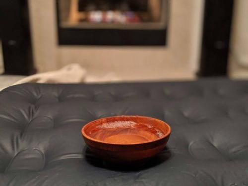 a wooden bowl on the bed with oil in it